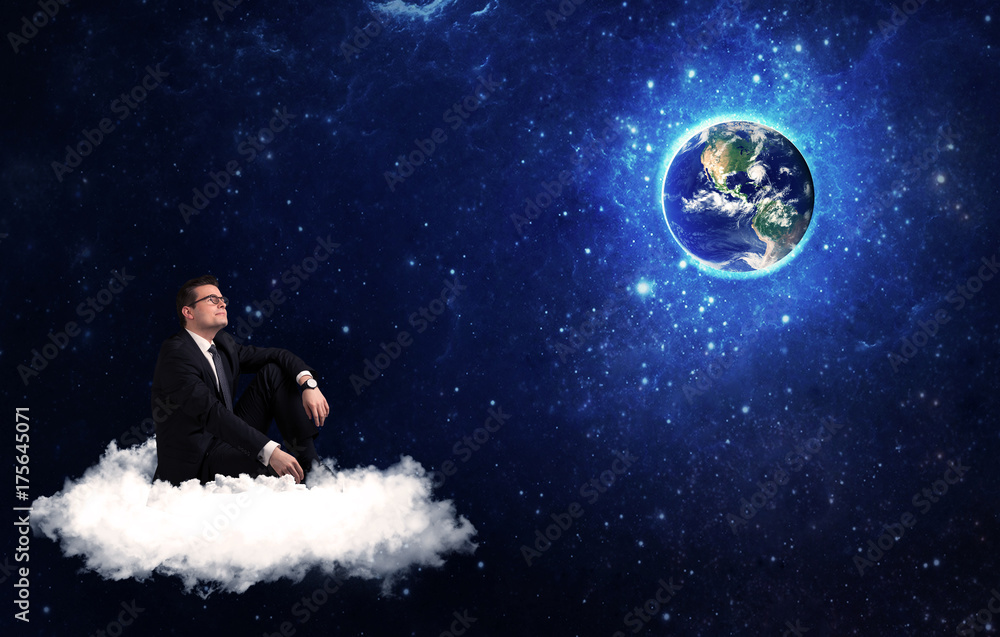 Man sitting on cloud looking at planet earth Man sitting on cloud looking at planet earth