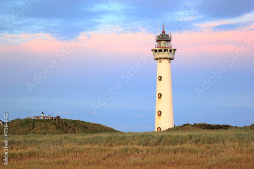 Lighthouse at sunset in the twilight. Egmond aan Zee, North Sea, the Netherlands.