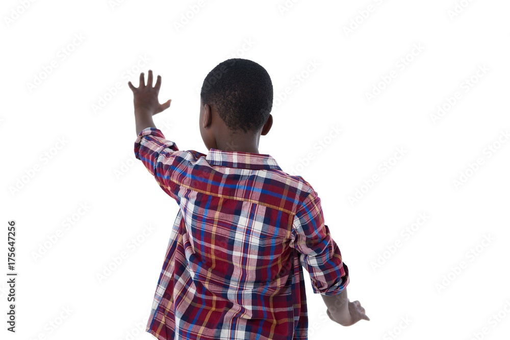 Boy pretending to touch an invisible screen against white Boy pretending to touch an invisible screen against white