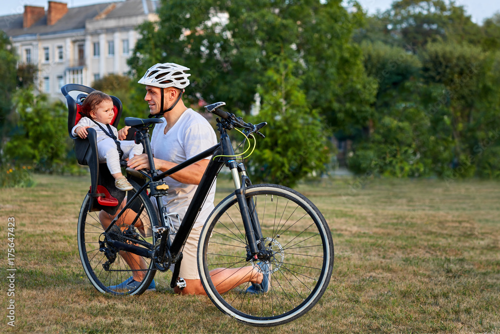 cute girl on bike seat cycling with father in the city cute girl on bike seat cycling with father in the city