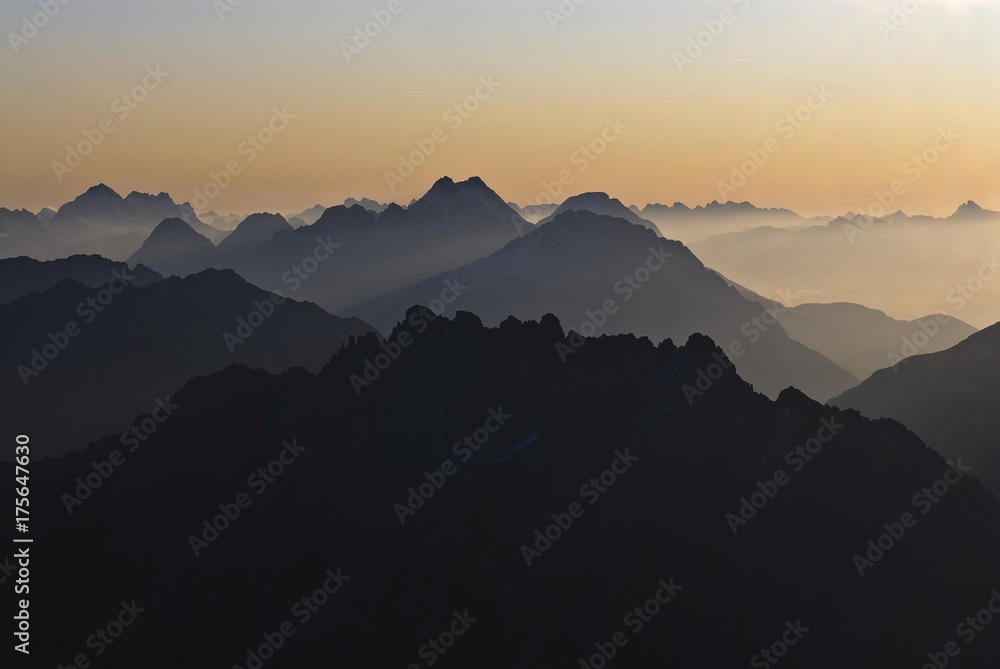 Sunrise with rows of mountains with hazy valleys, Namlos, Reutte, Tyrol, Austria, Europe