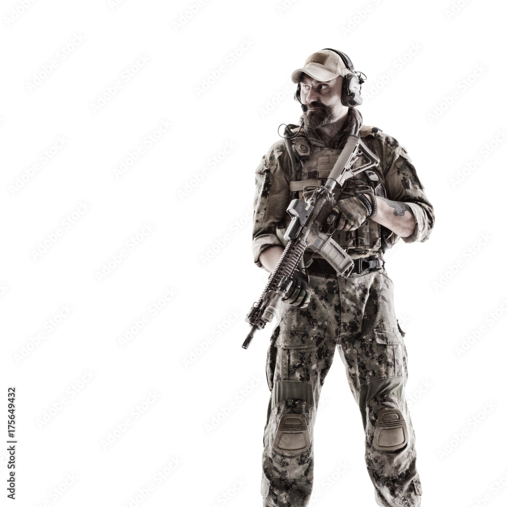 Half length low angle studio shot of special forces soldier in field uniforms with weapons on his shoulder, portrait isolated on white background