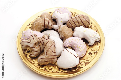 Frosted gingerbread cookies on an ornate golden plate