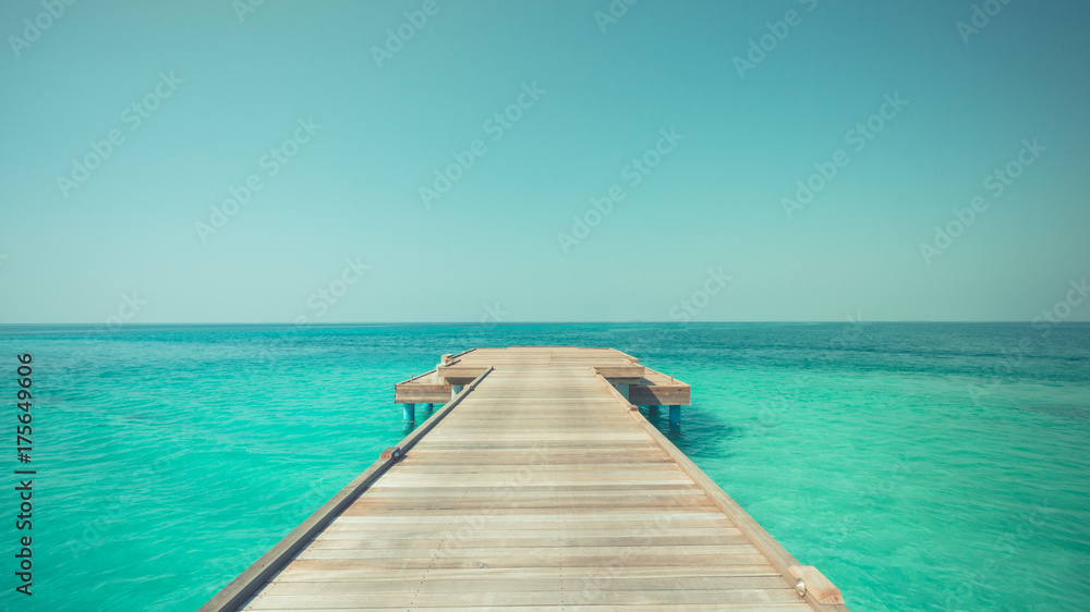 Inspirational beach scene. Endless blue sea and wooden pier Inspirational beach scene. Endless blue sea and wooden pier