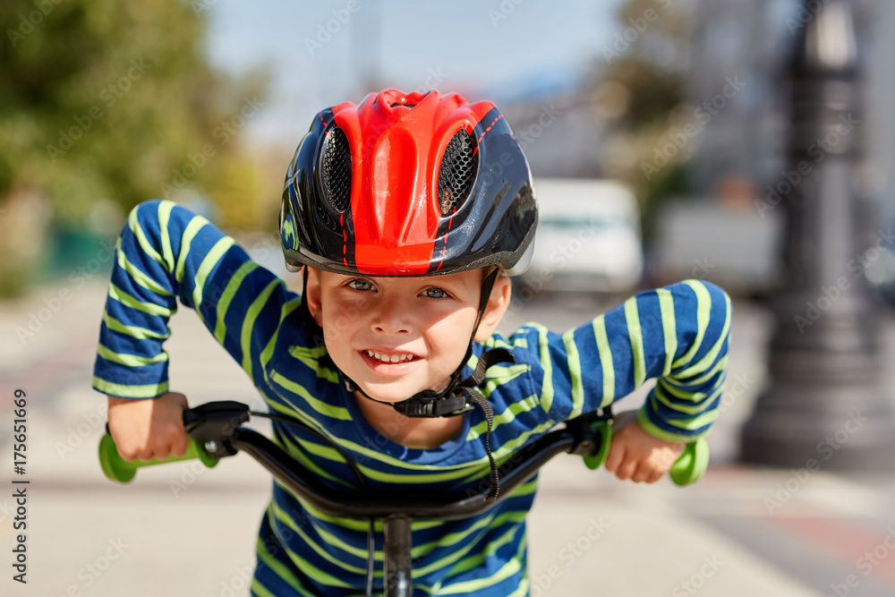 Boy in helmet standing with bike at autumn park Boy in helmet standing with bike at autumn park