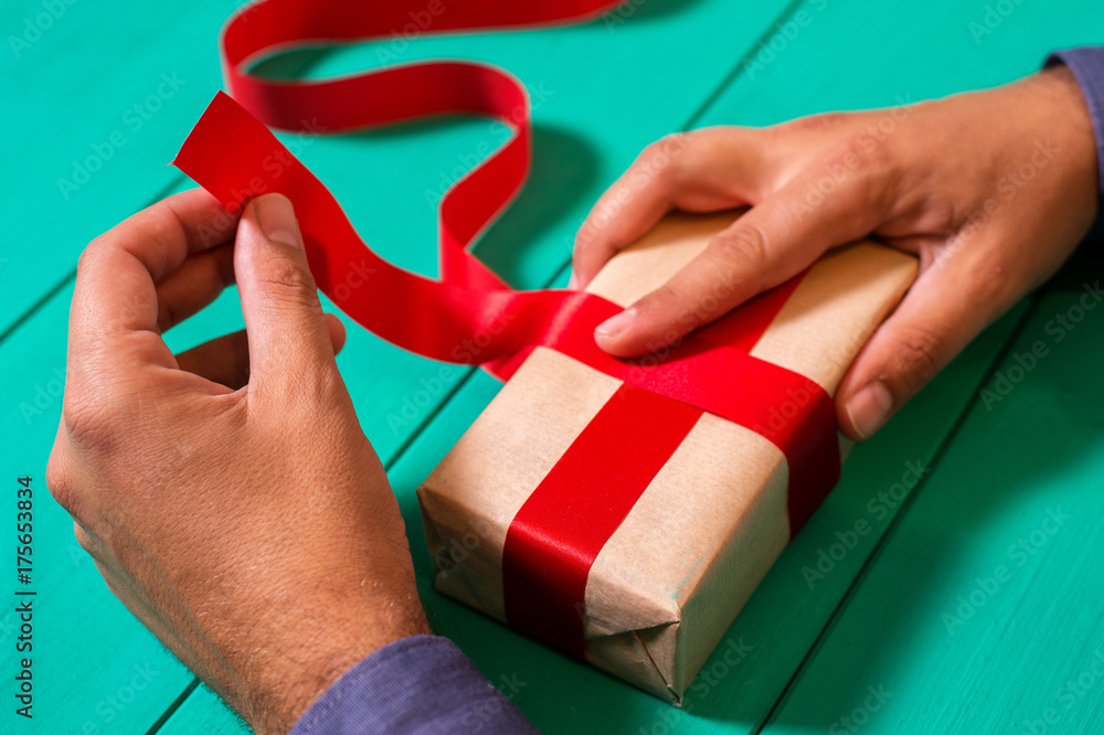 Man wraping a christmas present Man wraping a christmas present