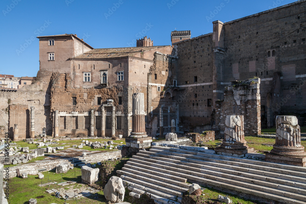 a view of ancient ruins in Roman Forum in Rome, Italy on a sunny summer day