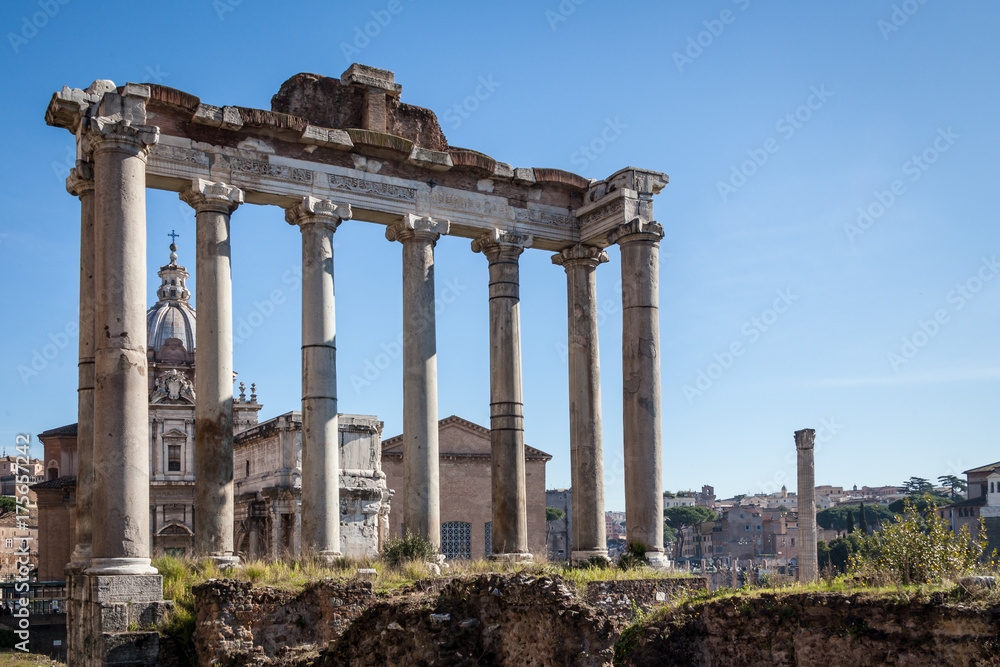 ruins of Temple of Saturn at Roman Forum with blue sky ruins of Temple of Saturn at Roman Forum with blue sky
