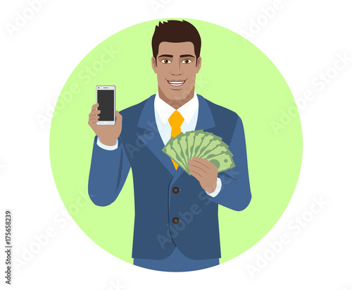 Businessman holding mobile phone and money