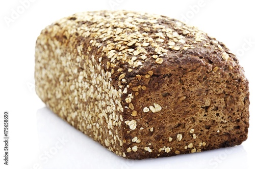 Wholegrain bread topped with oat flakes photo