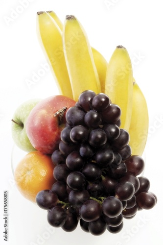 Vitamins, bowl of fruit: apples, orange, bananas and red grapes