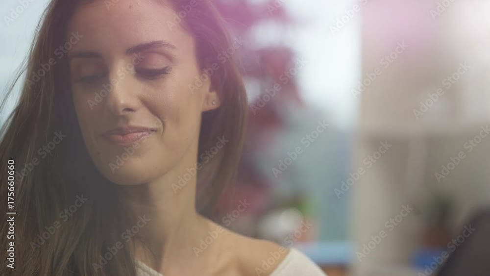 Happy woman at home talking on phone and working on laptop Happy woman at home talking on phone and working on laptop