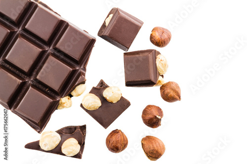 Pieces of bitter dark chocolate cubes with hazelnut isolated on white background, top view