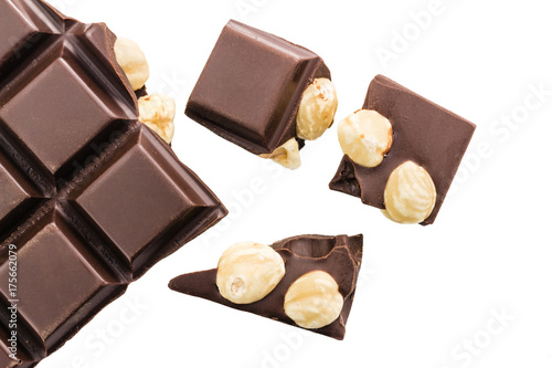 Pieces of bitter dark chocolate cubes with hazelnut isolated on white background, top view