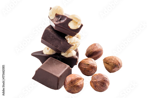 Pieces of bitter dark chocolate cubes with hazelnut isolated on white background