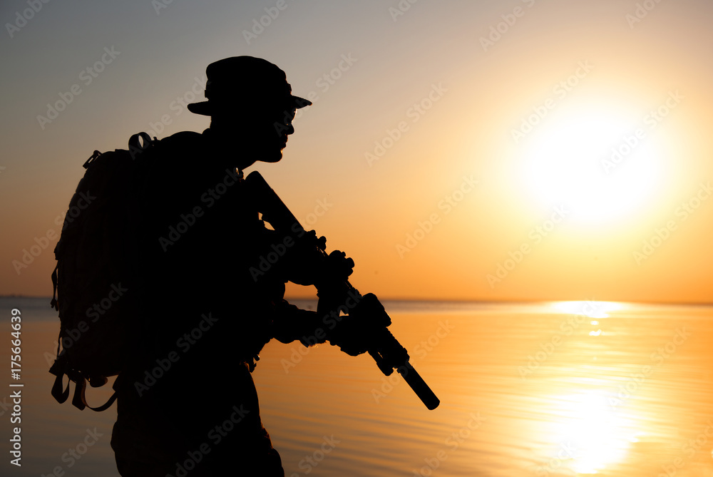 Army soldier with rifle orange sunset silhouette Army soldier with rifle orange sunset silhouette