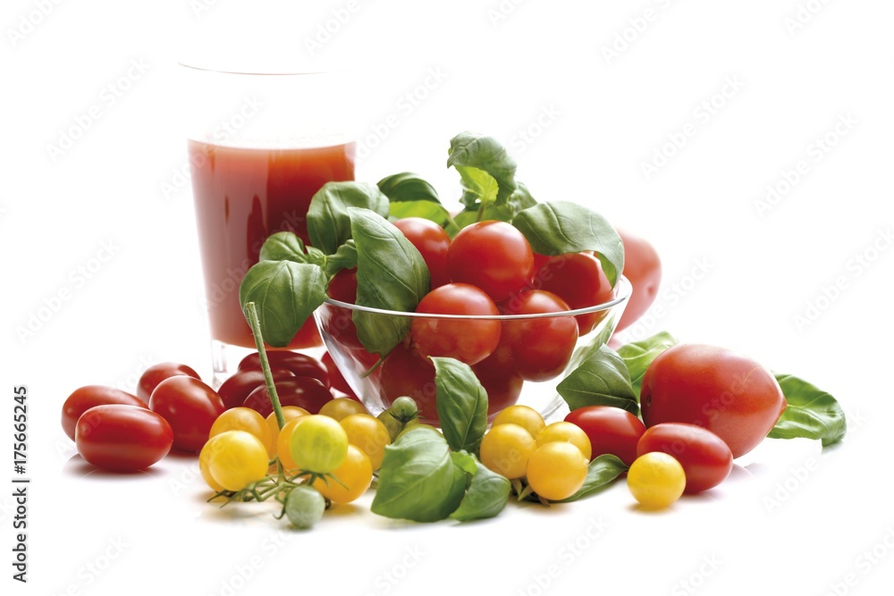Red and yellow grape tomatoes with tomato juice and basil Red and yellow grape tomatoes with tomato juice and basil