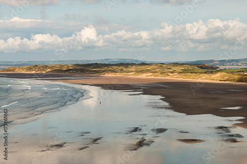 Late afternoon at low tide on a large, sandy beach