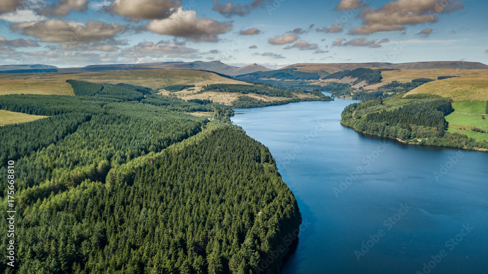 A lake surrounded by forest in an upland area viewed from the air