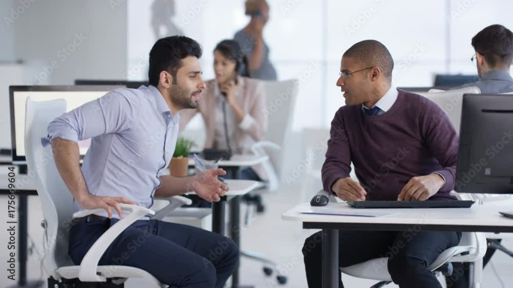 Business group working in office, 2 businessmen having a conversation Business group working in office, 2 businessmen having a conversation