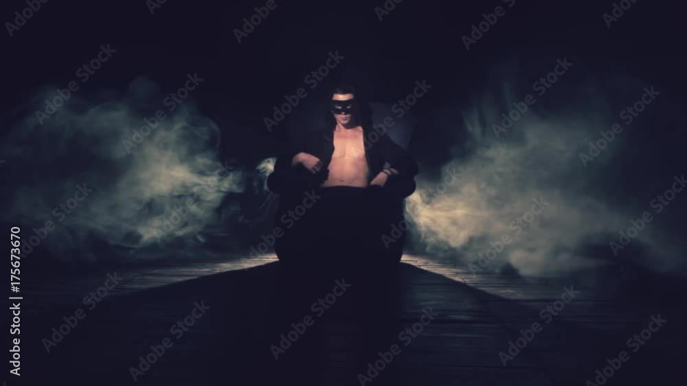 Sexy man sitting in a chair in smoke Sexy man sitting in a chair in smoke