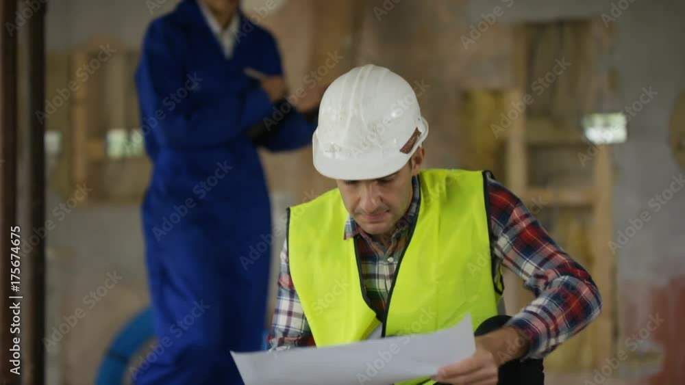 Male architect & female engineer having a discussion at construction site Male architect & female engineer having a discussion at construction site