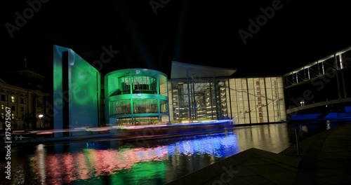 Photography Illuminated ship passing a building in Berlin's administration district during t