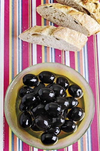 Black olives and olive-ciabatta slices photo