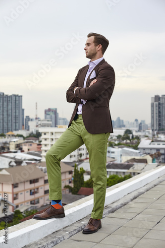 Portrait caucasian hipster stunna guy in stylish suit with brown top photo