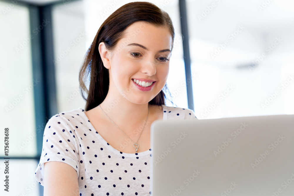 Portrait of businesswoman working at computer in office Portrait of businesswoman working at computer in office