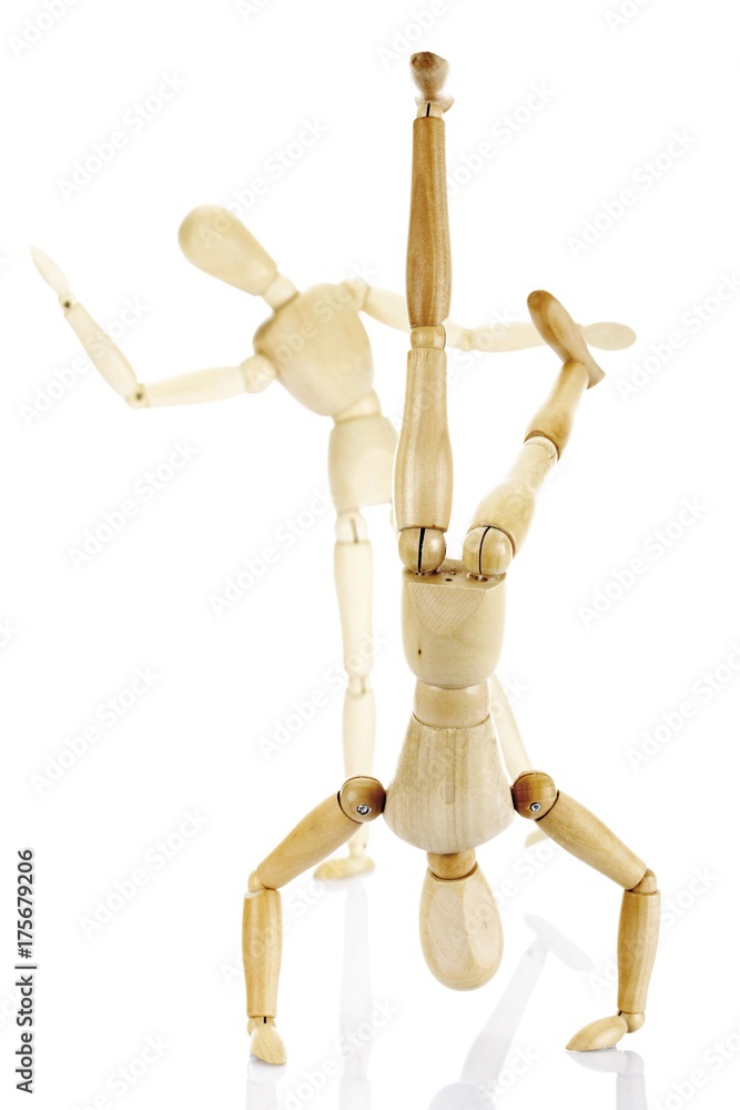 Jointed wooden mannequins performing exercises Jointed wooden mannequins performing exercises
