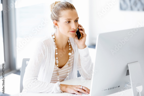 Attractive office worker sitting at desk