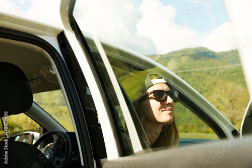 A girl enjoying the view from her car in the mountains of abkhazia