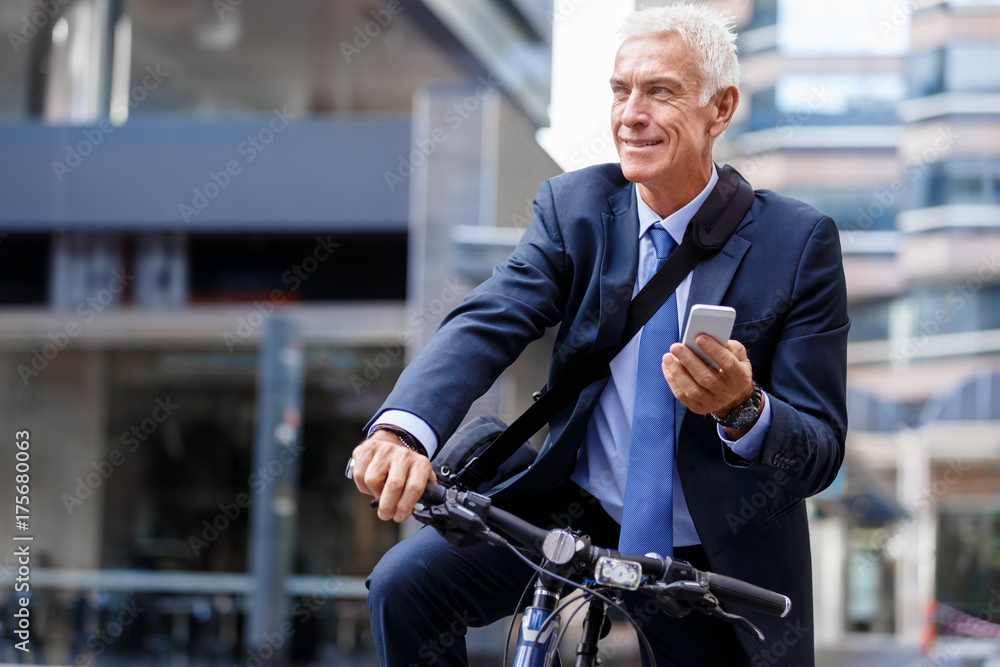 Successful businessman riding bicycle Successful businessman riding bicycle