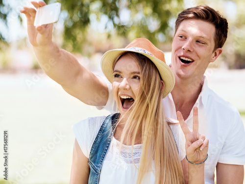 Young couple doing selfie outdoors