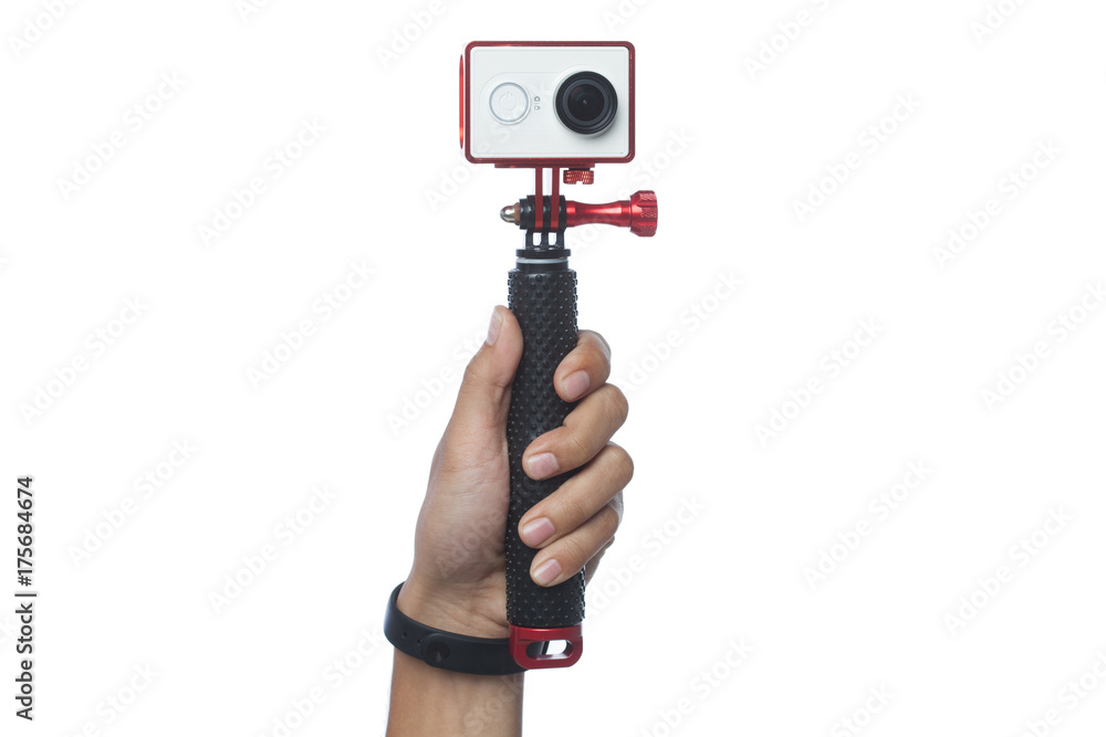 a hand is holding a action camera with monopod stick isolated with white background