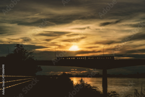 Silhouette of a train on a bridge over the Mekong River This bridge connects Thailand and Laos. © chaisiri