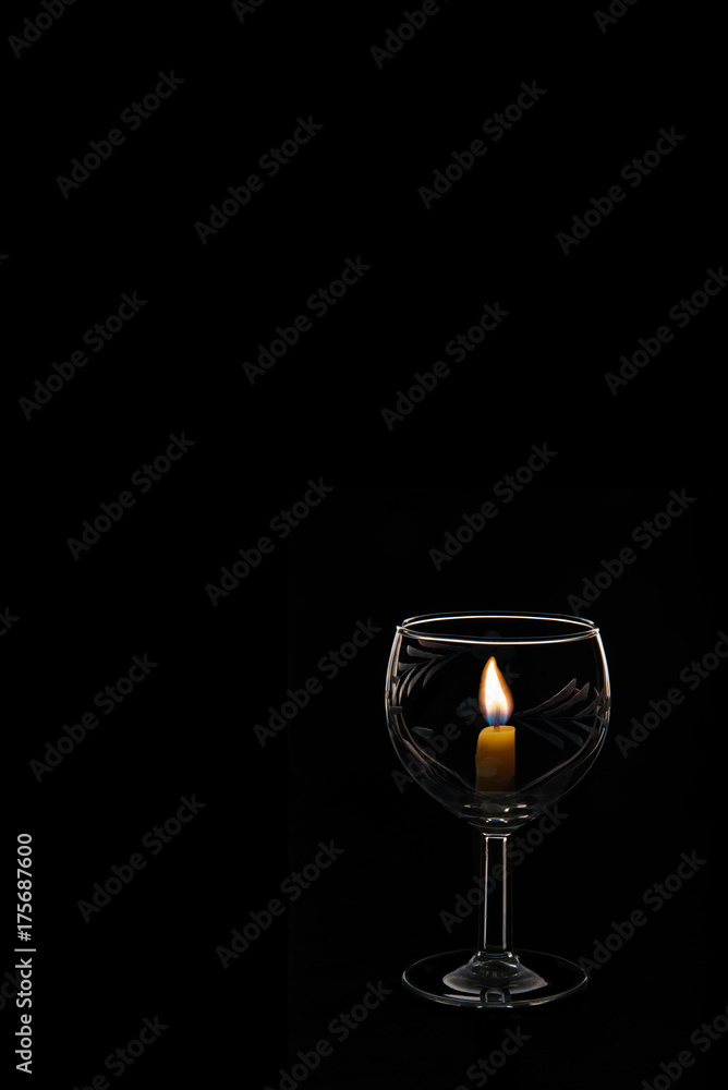 candle light in Champagne glass on a black background candle light in Champagne glass on a black background