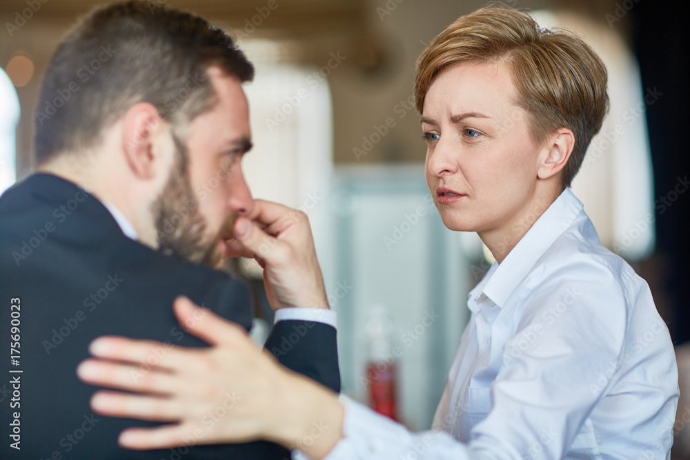 Helpful colleague comforting frustrated businessman in trouble Helpful colleague comforting frustrated businessman in trouble