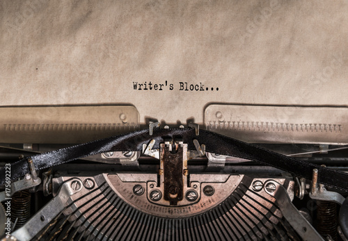 Writer's Block words typed on a Vintage Typewriter. Mechanisms closeup. Typing on old typewriter