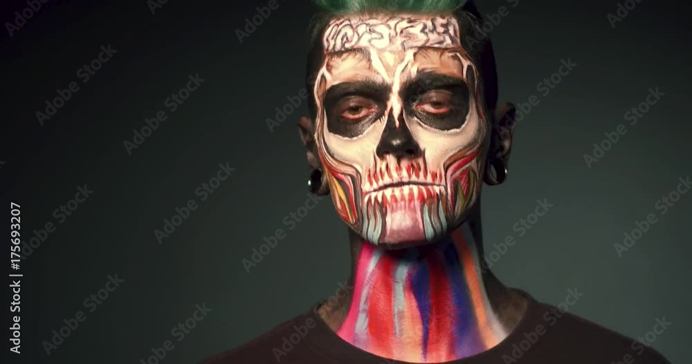 Mystical face art. Man on black backgrounf with colored skull makeup. Mystical face art. Man on black backgrounf with colored skull makeup.