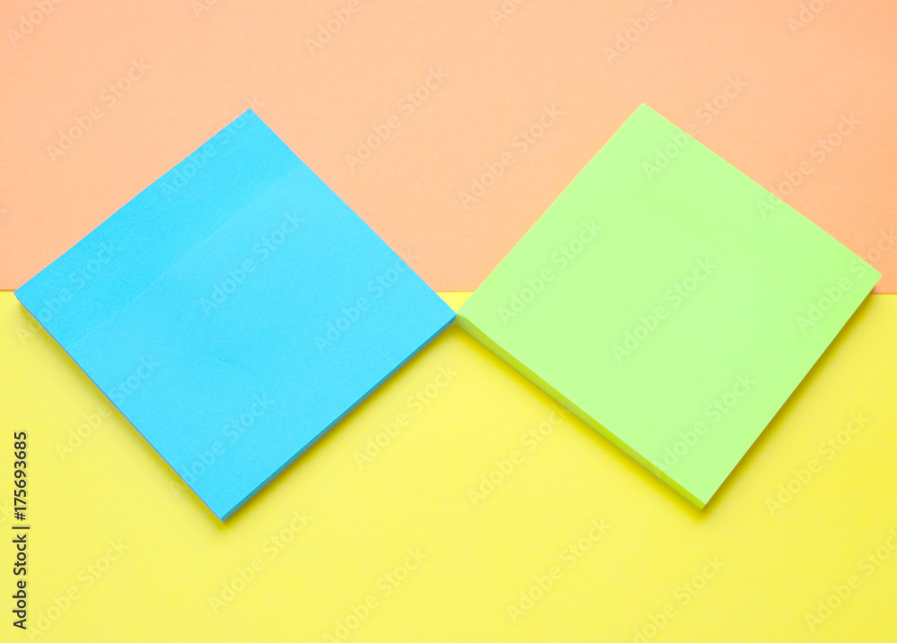 blue and light green sticks note on yellow with a coral background.Flat.Paper for writing ideas.Memo blue and light green sticks note on yellow with a coral background.Flat.Paper for writing ideas.Memo