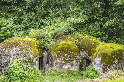 Old, covered with moss, military concrete earthworks.