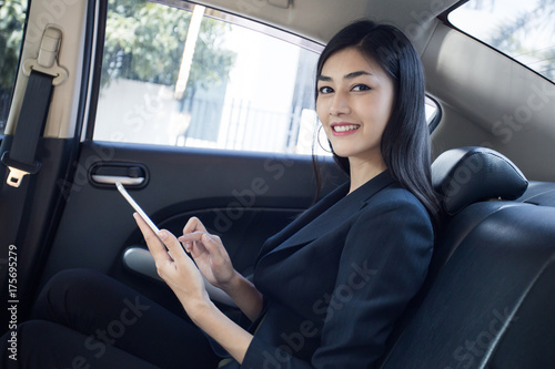 Woman using Smartphone for working in car, Woman working concept. © Bavorndej