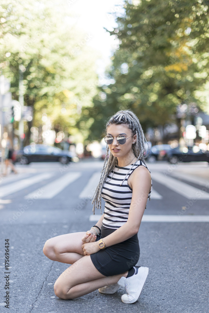 Hipster young woman with braided hair in the street.