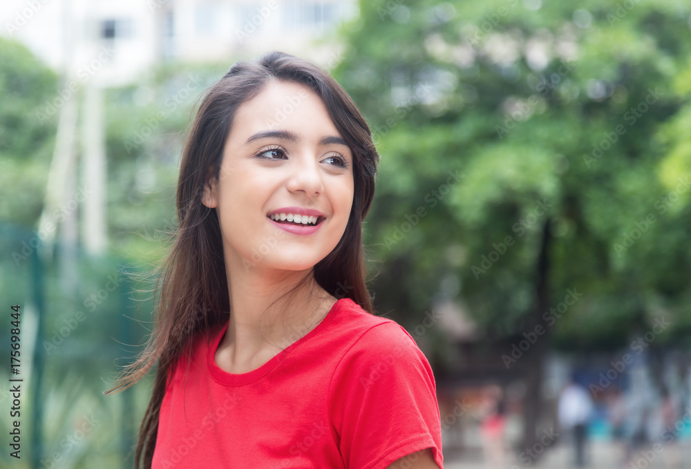 Attractive woman in a red shirt outdoor in a park