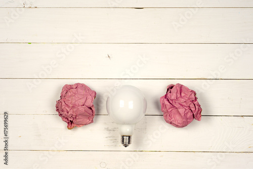 great idea concept with crumpled colorful paper and light bulb on light background photo