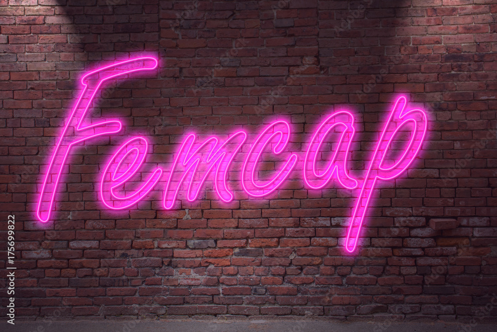 Obraz premium Leuchtreklame Femcap an Ziegelsteinmauer