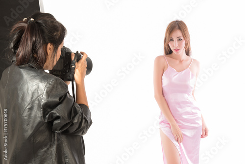 Photographer working with model in  studio. Asian woman photography in action.