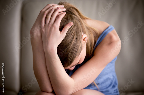 Photography Sad teenager crying alone holding head in hands, feeling depressed, regrets of m